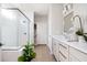 Modern bathroom featuring a glass-enclosed shower, sleek white vanity, and neutral tile flooring at 412 Southbridge Pass, Peachtree City, GA 30269