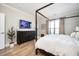 Bedroom featuring a four-poster bed, television, and decorative curtains at 412 Southbridge Pass, Peachtree City, GA 30269