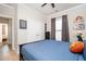 Bedroom featuring hardwood floors, closet, and ensuite access to the hallway at 412 Southbridge Pass, Peachtree City, GA 30269