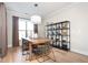Dining room with a rustic wood table, modern chairs, an industrial shelving unit, and natural light from a large window at 412 Southbridge Pass, Peachtree City, GA 30269