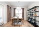 Bright dining room featuring a stylish table setting, contemporary light fixture, and a minimalist shelving unit at 412 Southbridge Pass, Peachtree City, GA 30269