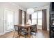 Well-lit dining area with a wooden table, modern chairs, and a convenient door leading to the outside at 412 Southbridge Pass, Peachtree City, GA 30269