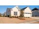 A view of the front of the home, highlighting the lawn and landscaping at 412 Southbridge Pass, Peachtree City, GA 30269