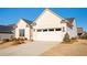 Light-colored brick home with a two-car garage and tidy landscaping at 412 Southbridge Pass, Peachtree City, GA 30269
