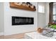Close-up of a modern fireplace with a wooden mantle and decorative baskets at 412 Southbridge Pass, Peachtree City, GA 30269