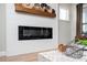 A modern fireplace with a shiplap accent wall and decorative shelf, enhancing the living space at 412 Southbridge Pass, Peachtree City, GA 30269