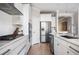 Modern kitchen featuring white cabinetry, stainless steel appliances, and sleek countertops with a stylish sink at 412 Southbridge Pass, Peachtree City, GA 30269