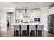 Bright kitchen with white cabinetry, stainless steel appliances, and an island with bar stool seating at 412 Southbridge Pass, Peachtree City, GA 30269
