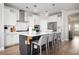 Stylish kitchen featuring white cabinets, stainless steel appliances, and an island with seating at 412 Southbridge Pass, Peachtree City, GA 30269