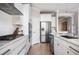 Well-equipped kitchen with white cabinetry, stainless steel appliances, and modern finishes at 412 Southbridge Pass, Peachtree City, GA 30269