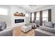 Cozy living room with modern fireplace, shiplap accent wall, and comfortable seating arrangement at 412 Southbridge Pass, Peachtree City, GA 30269