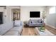 Spacious living room showcases hardwood floors, comfortable gray seating, and stylish decor with lots of natural light at 412 Southbridge Pass, Peachtree City, GA 30269