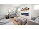 Comfortable living room featuring a modern fireplace, stylish decor, and plenty of seating space at 412 Southbridge Pass, Peachtree City, GA 30269