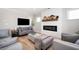 Living room with decorative fireplace, neutral furniture, and hardwood flooring at 412 Southbridge Pass, Peachtree City, GA 30269