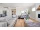 Open-concept living room connecting to the kitchen, featuring hardwood floors and neutral furnishings at 412 Southbridge Pass, Peachtree City, GA 30269
