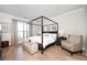 Bright main bedroom with four-poster bed, neutral decor, and ample natural light at 412 Southbridge Pass, Peachtree City, GA 30269