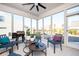 Bright sunroom with multiple windows, comfortable seating, and an outdoor grill for relaxation and entertainment at 412 Southbridge Pass, Peachtree City, GA 30269