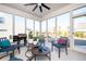 Bright sunroom with large windows, comfortable seating, ceiling fan, and outdoor views at 412 Southbridge Pass, Peachtree City, GA 30269