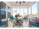 Inviting sunroom with ample natural light, cozy seating arrangement, and views of the landscaped backyard at 412 Southbridge Pass, Peachtree City, GA 30269