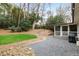 Landscaped backyard with a patio, gravel area, stone steps, and a screened-in porch at 472 Carolwood Ln, Atlanta, GA 30342