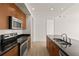 Modern kitchen with stainless steel appliances and wood cabinets at 565 Peachtree Ne St # 1005, Atlanta, GA 30308