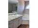 Main bathroom with a vanity, garden tub, and tiled floor at 10561 Aspenwood Ct, Jonesboro, GA 30238