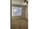 Well-lit bedroom with carpet and window coverings at 10561 Aspenwood Ct, Jonesboro, GA 30238