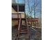 Two tiered wooden deck with access stairs at 10561 Aspenwood Ct, Jonesboro, GA 30238