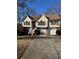 Two-story house with attached garage, manicured lawn, and a charming front entrance at 10561 Aspenwood Ct, Jonesboro, GA 30238
