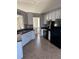 Kitchen with white cabinets, black appliances, and tile flooring at 10561 Aspenwood Ct, Jonesboro, GA 30238
