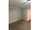 Living room with neutral walls and carpet at 10561 Aspenwood Ct, Jonesboro, GA 30238