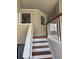 Elegant staircase with wooden steps and white railings leading to the upper level at 10561 Aspenwood Ct, Jonesboro, GA 30238