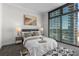Bright bedroom with large windows, city views, and stylish decor at 270 17Th Nw St # 1608, Atlanta, GA 30363