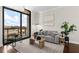Living room with hardwood floors, large windows and city views at 270 17Th Nw St # 1608, Atlanta, GA 30363