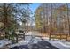 Driveway lined with trees, partially covered in snow at 323 Winding Stream Trl, Hampton, GA 30228