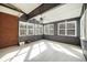 Sunroom with tile floor, ceiling fan and large windows at 323 Winding Stream Trl, Hampton, GA 30228