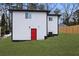 Rear view of house, red door, and fenced yard at 951 Reed Ave, Atlanta, GA 30344