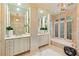 Bright bathroom with double vanity, decorative mirrors, plantation shutters and a soaking tub with tile surround at 2522 Habersham Nw Rd, Atlanta, GA 30305