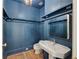 Stylish blue bathroom features a pedestal sink, wood-look floors, and decorative trim at 2522 Habersham Nw Rd, Atlanta, GA 30305