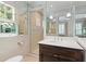 Bathroom featuring a sink with dark wood cabinet, white tile walls and a shower with glass door at 2522 Habersham Nw Rd, Atlanta, GA 30305