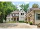 Stunning two-story home with a stone archway and elegant landscaping, nestled among lush greenery at 2522 Habersham Nw Rd, Atlanta, GA 30305