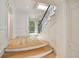 Bright foyer featuring staircase with wrought iron railing and view to the front door at 2522 Habersham Nw Rd, Atlanta, GA 30305