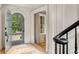 Foyer view showcasing the open door, hardwood floors, and elegant architectural details at 2522 Habersham Nw Rd, Atlanta, GA 30305