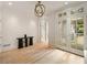 Bright foyer with hardwood floors, transom-topped French doors, and modern lighting at 2522 Habersham Nw Rd, Atlanta, GA 30305