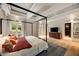 Spacious main bedroom with a four-poster bed and an en suite bathroom with large windows at 2522 Habersham Nw Rd, Atlanta, GA 30305