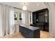 Chic office features built-in shelving, hardwood floors, and large windows with curtains at 2522 Habersham Nw Rd, Atlanta, GA 30305