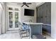 Outdoor bar area featuring built-in cabinets, bar seating, and ceiling fan at 2522 Habersham Nw Rd, Atlanta, GA 30305