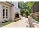 Outdoor patio featuring a stone fireplace and well-manicured landscaping at 2522 Habersham Nw Rd, Atlanta, GA 30305
