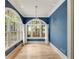 Bright sunroom showcases arch windows with white trim, blue walls, hardwood floors, and a modern light fixture at 2522 Habersham Nw Rd, Atlanta, GA 30305