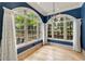 Bright sunroom features large arch windows and hardwood floors, perfect for enjoying natural light and views at 2522 Habersham Nw Rd, Atlanta, GA 30305